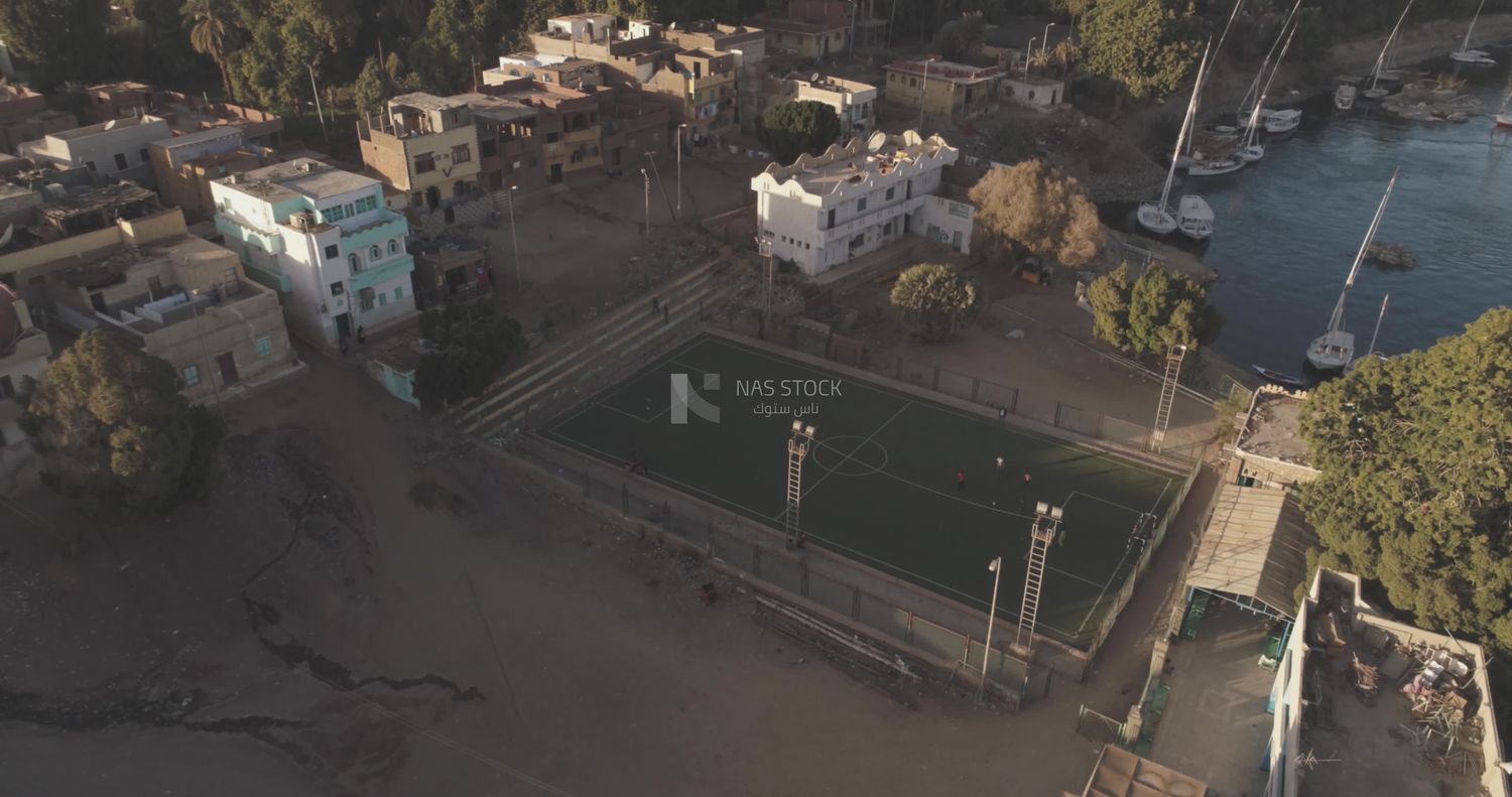 Drone footage of a stadium in front of the river