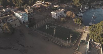 Drone footage of a stadium in front of the river