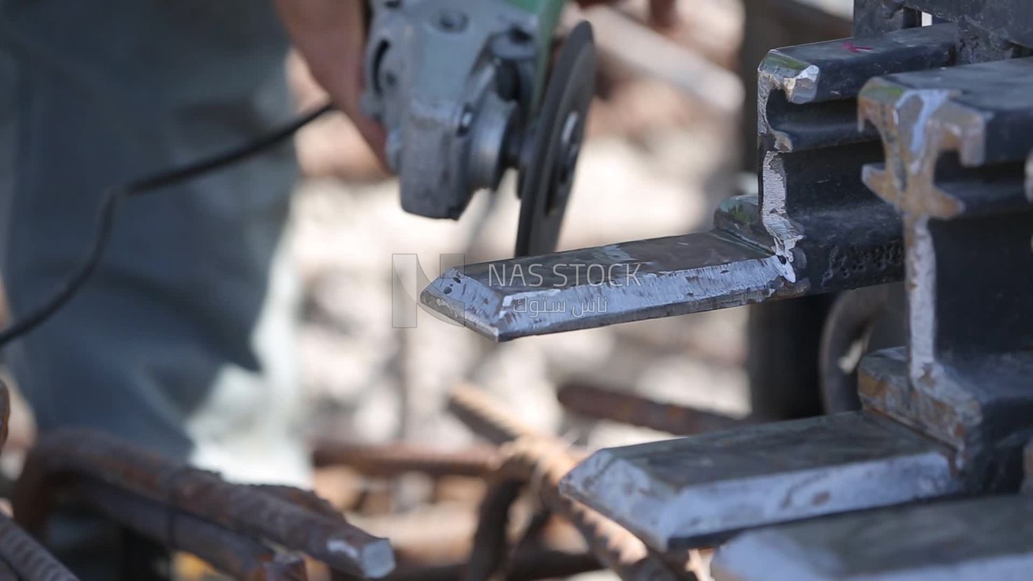 Worker cutting rebar by grinding machine,  engineering tools and equipment