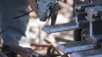 Worker cutting rebar by grinding machine,  engineering tools and equipment