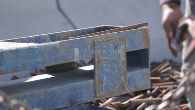 Two workers are trying to put the steel on a steel wire rope, work, construction, engineering tools and equipment
