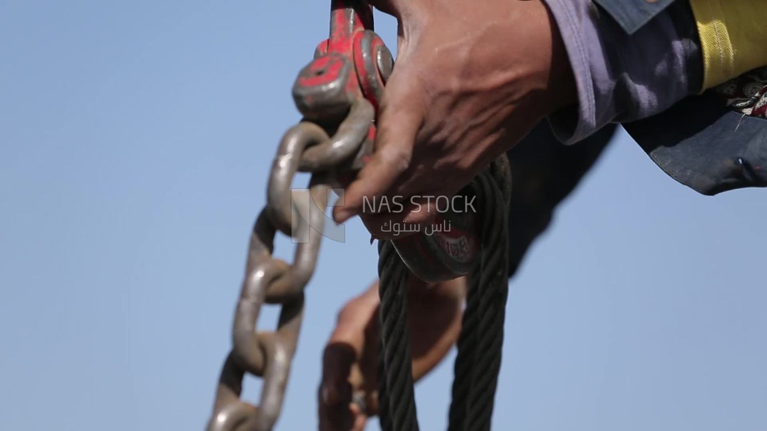 Worker trying to put the steel on a steel wire rope, work, construction, engineering tools and equipment