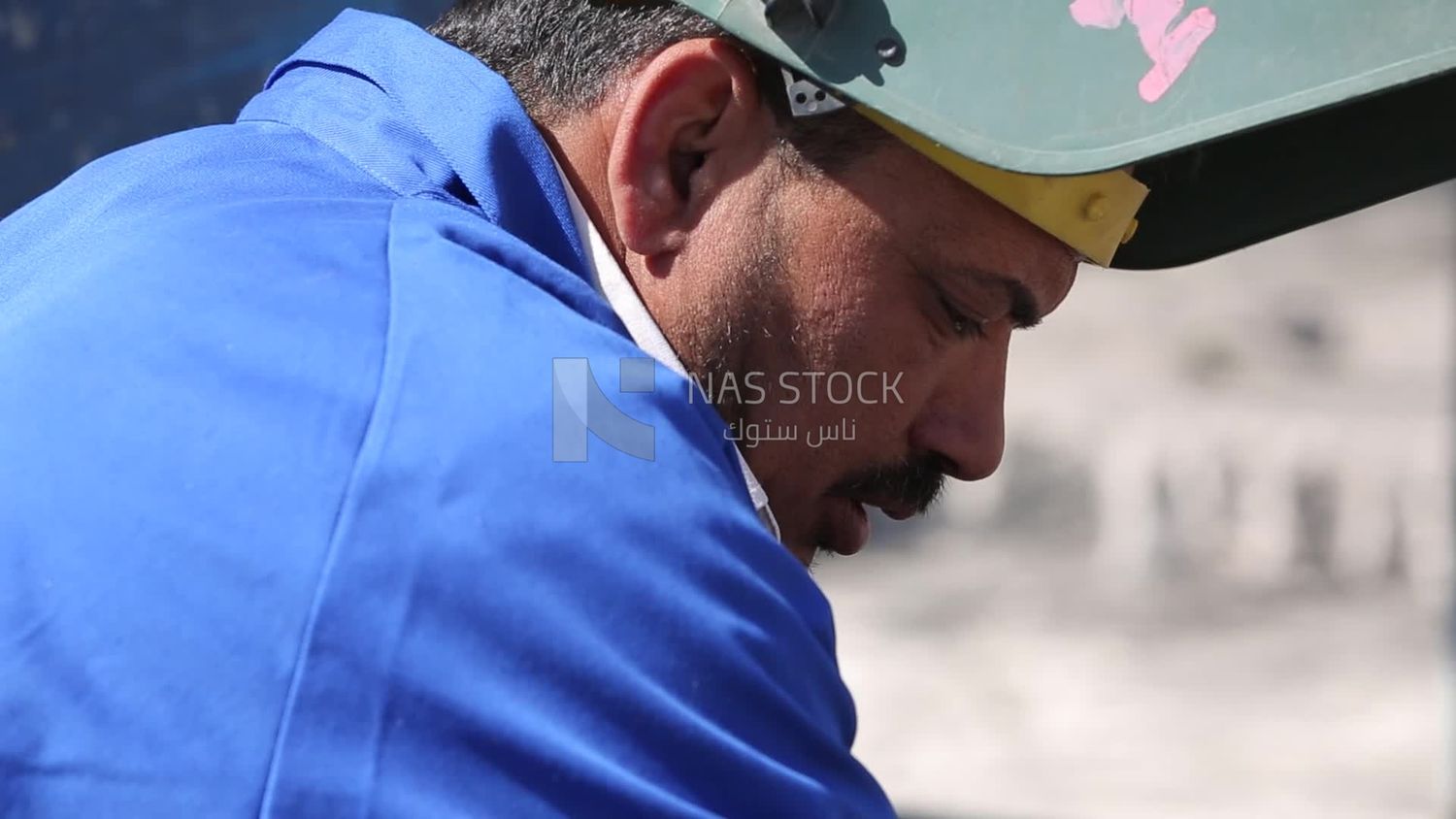 Worker using a drill to make a hole in the ground