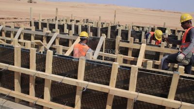 Group of men working on a site of solar energy