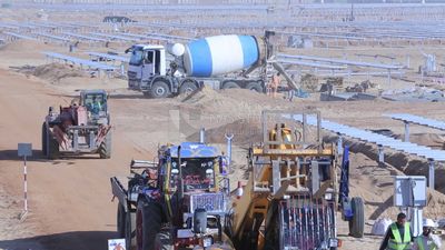 Group of men working on a site of solar energy