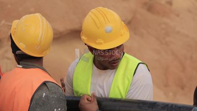 Group of workers holding an electric wire