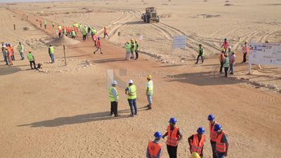 Group of men working on a site of solar energy