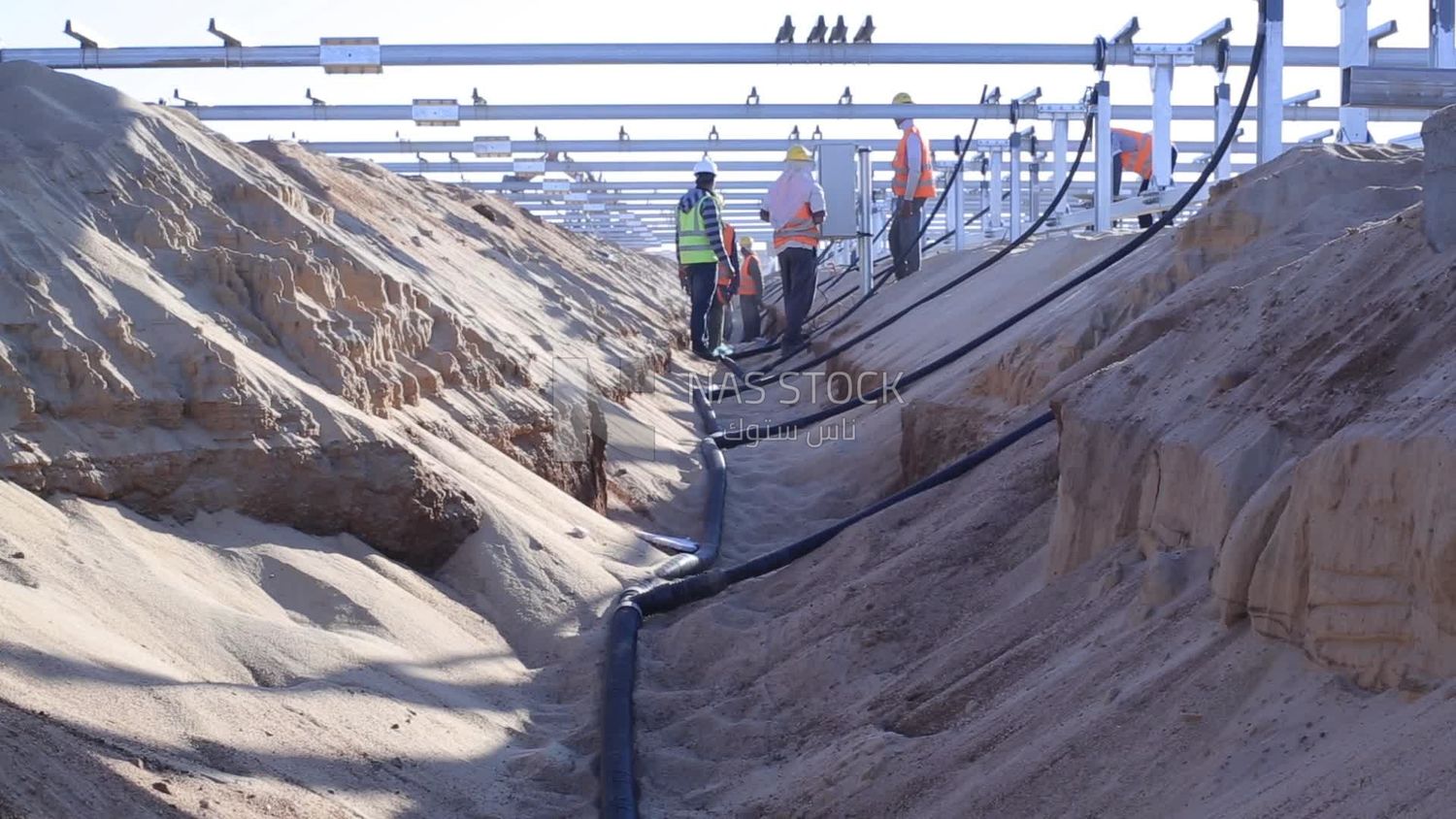 Group of men working on a site of solar energy