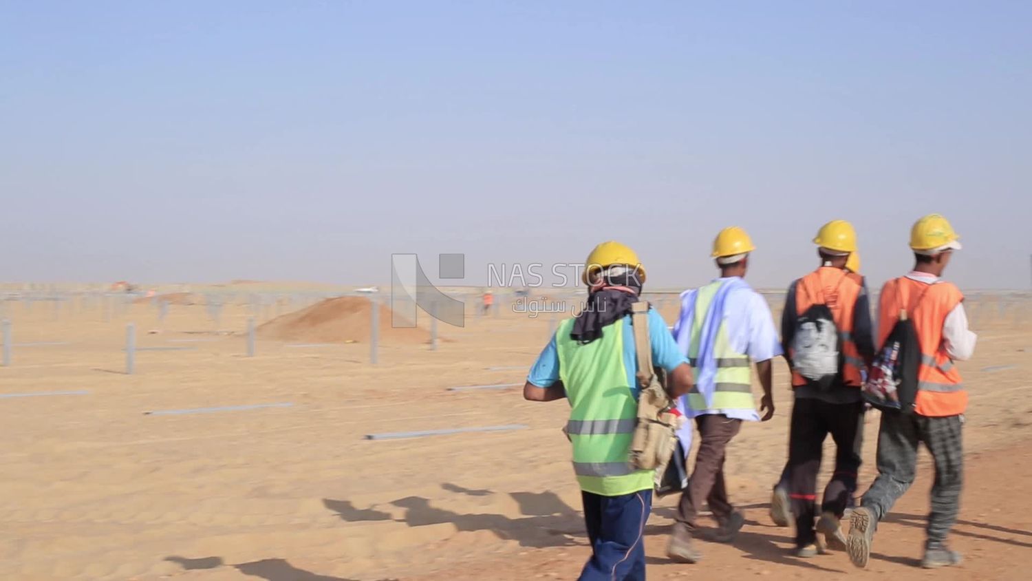 Group of men working on a site of solar energy