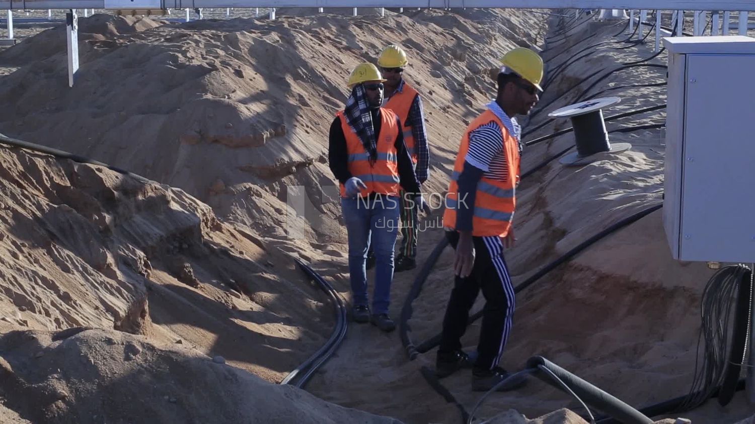 Group of men working on a site of solar energy