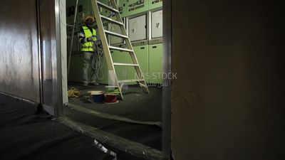 Man checking the electric wire of the ceiling
