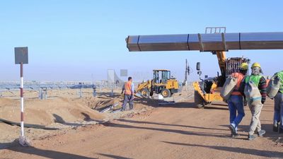 Man driving an excavator in solar energy