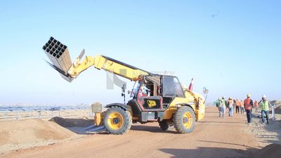 Man driving an excavator in solar energy