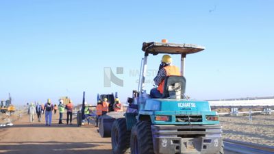 Group of men working on a site of solar energy