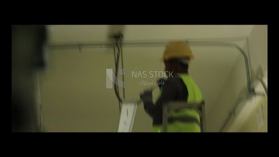 Man checking the electric wire of the ceiling