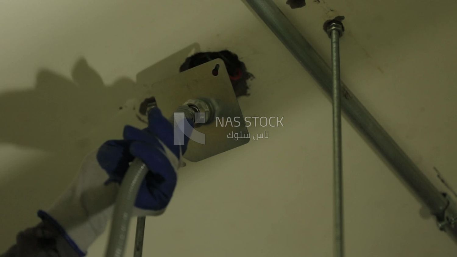 Man checking the electric wire of the ceiling
