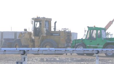 Man driving an excavator in solar energy