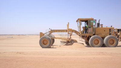 Man driving an excavator in solar energy