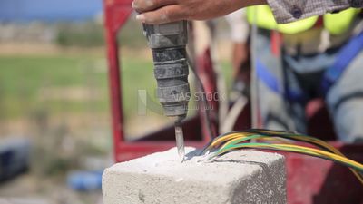 Man examines an electric wire