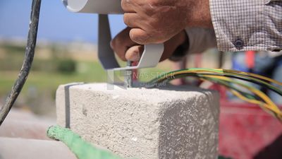 Man examines an electric wire