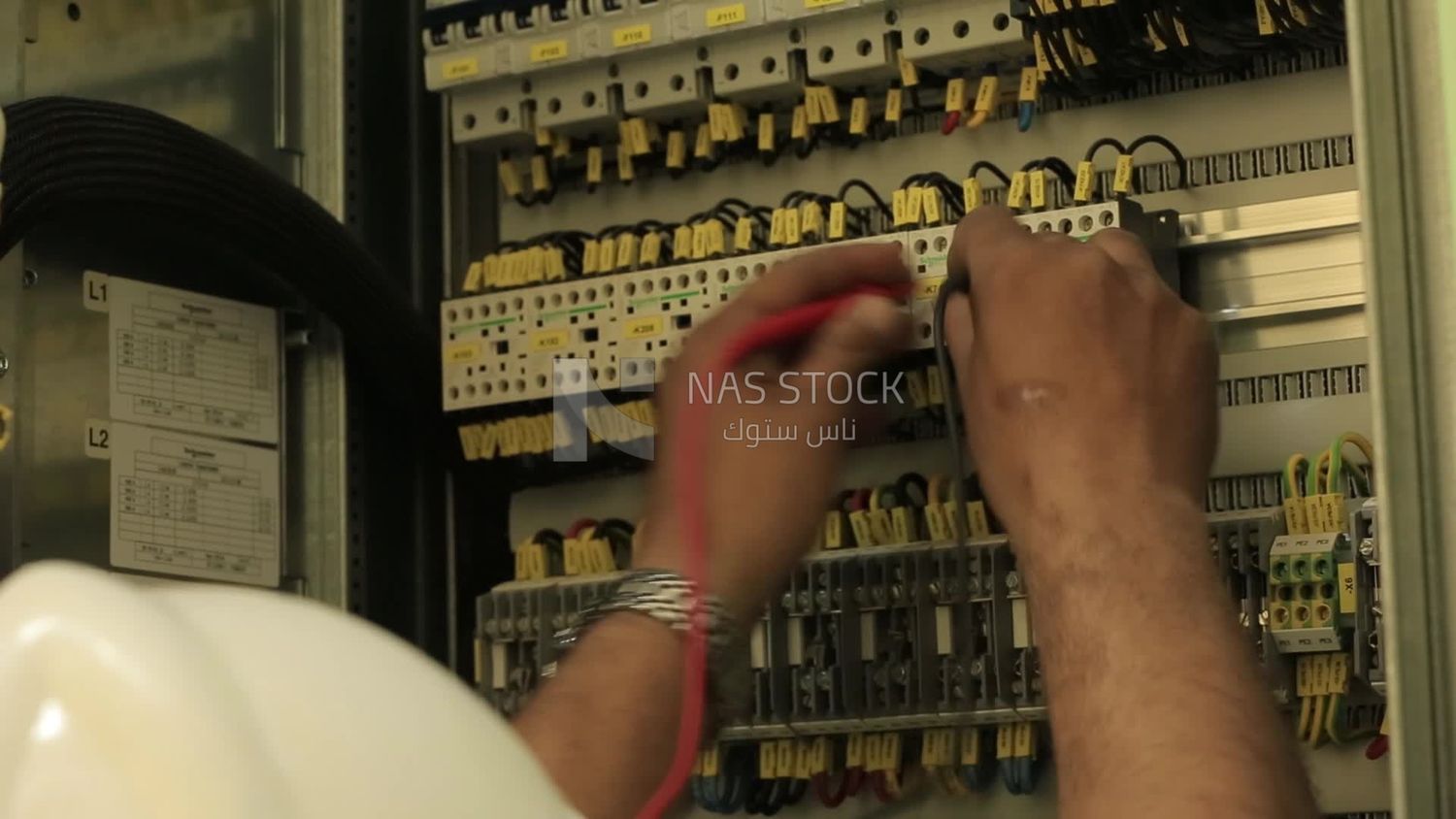 Man examines an electric wire