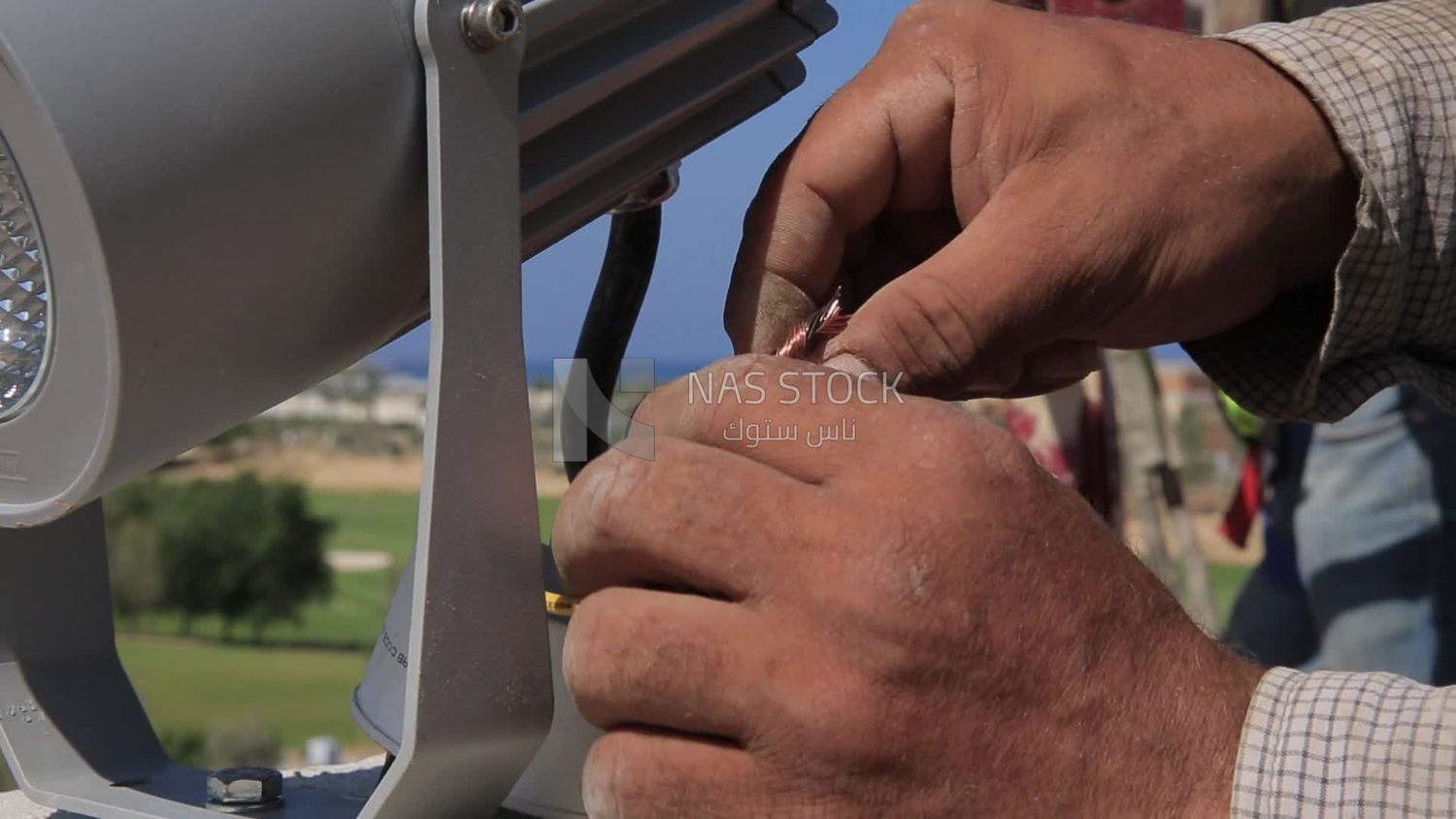 Man examines an electric wire, the use of maintenance tools and equipment