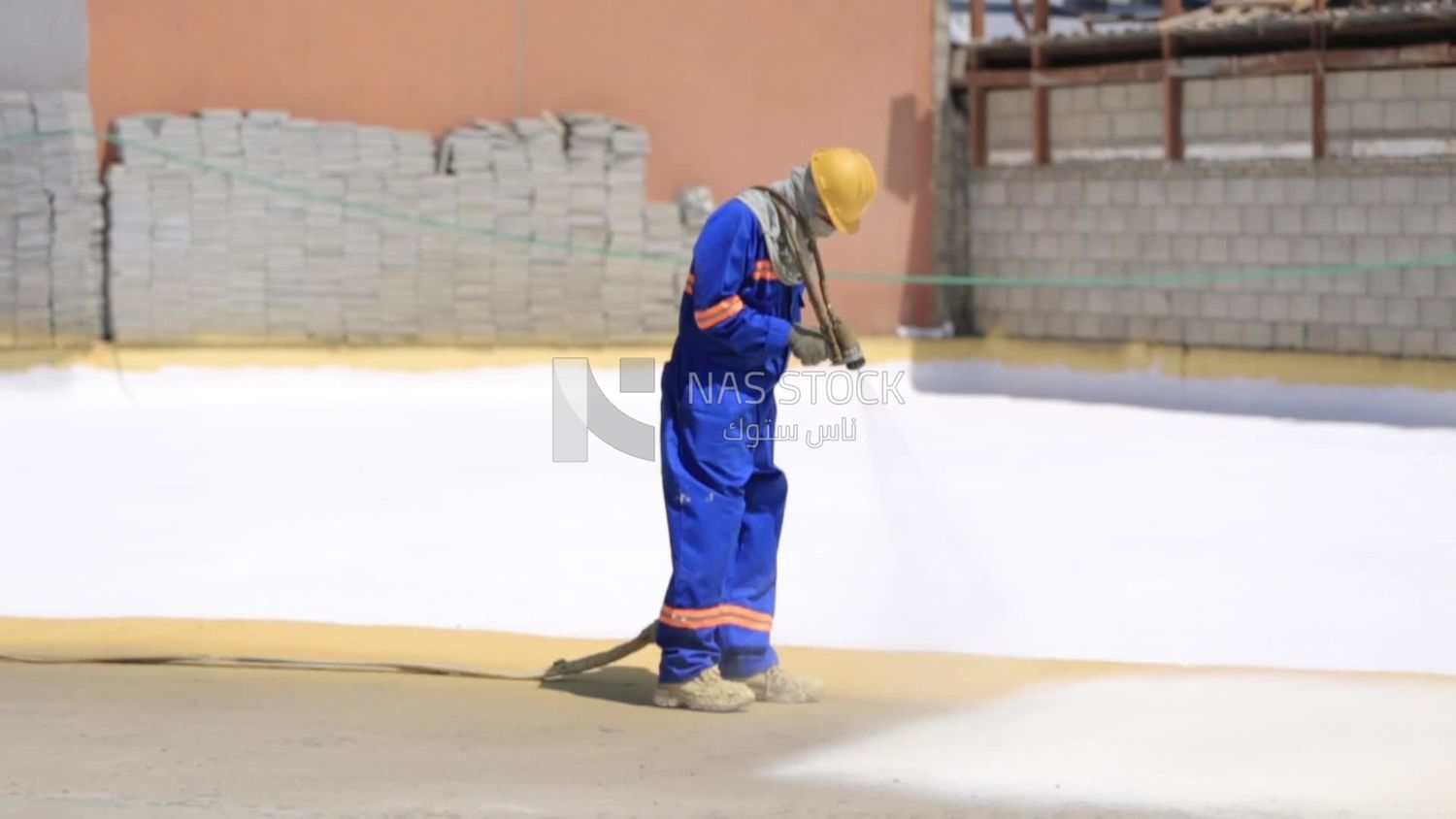Worker applies material insulating the building, Isolation work