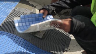 Worker puts cement on the floor at a building site