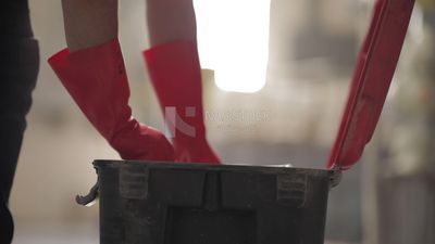 Worker puts paper into a box at a factory, factory equipment
