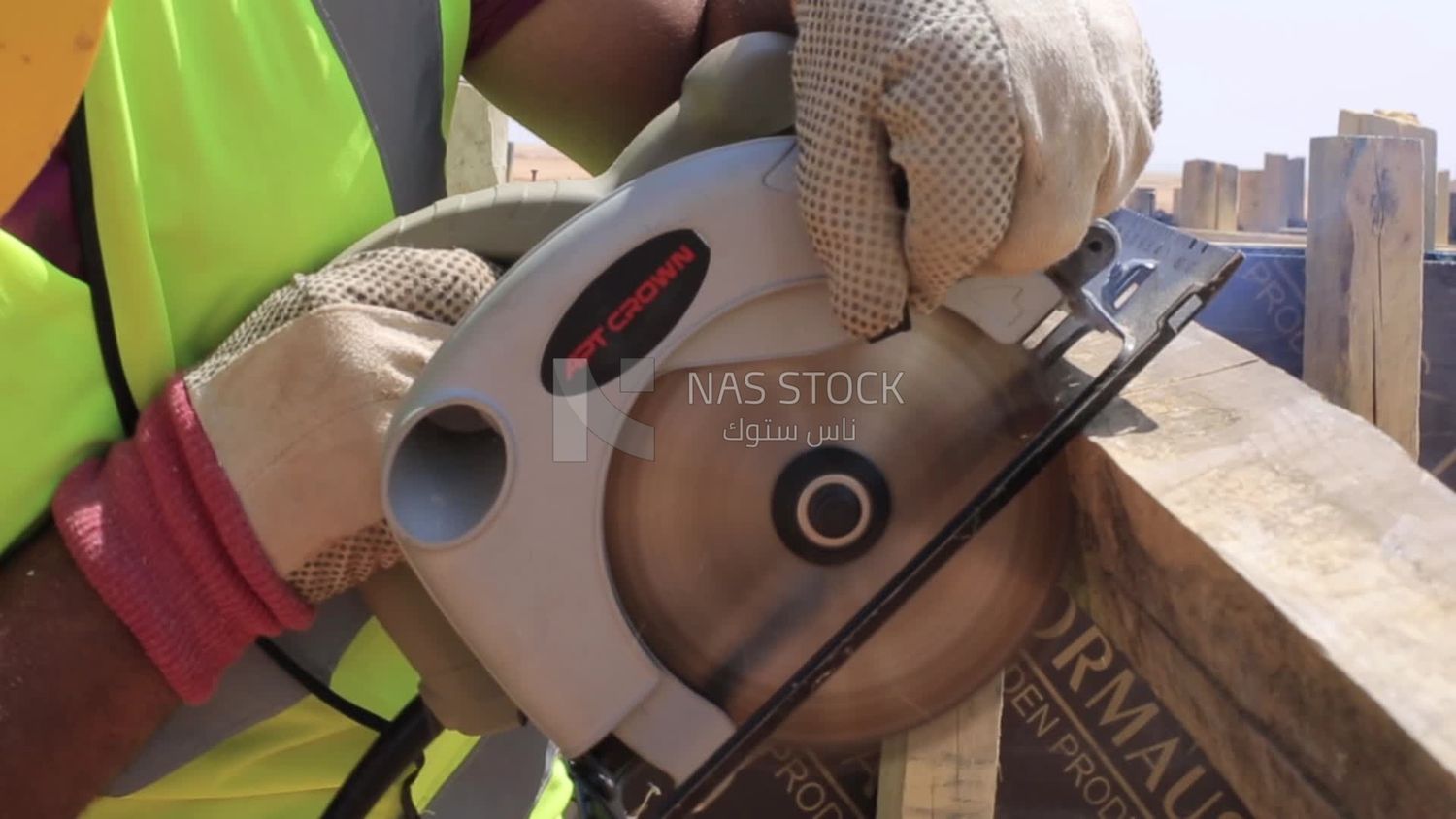Man cutting wood in a field of solar energy