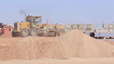 Man driving an excavator in solar energy