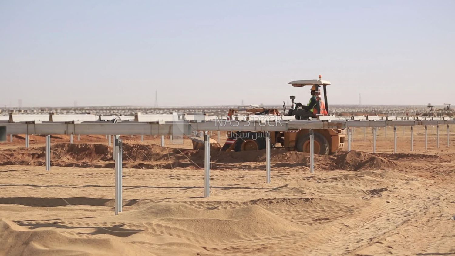 Man driving an excavator in solar energy