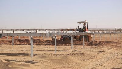 Man driving an excavator in solar energy