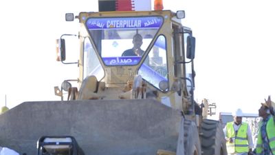Man driving an excavator in solar energy