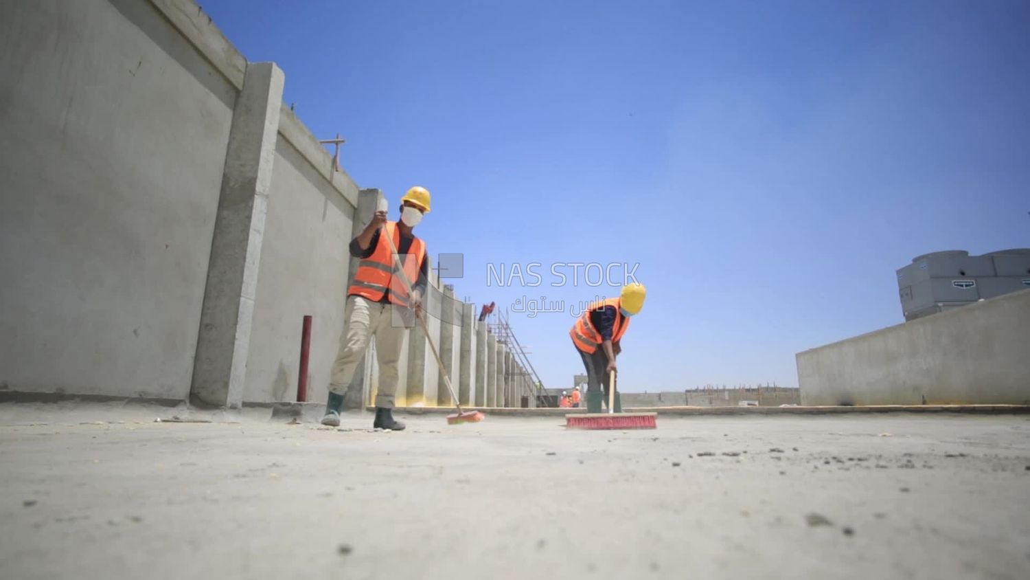 Workers clean the ground from broken bricks, Isolation work