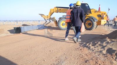 Man driving an excavator in solar energy