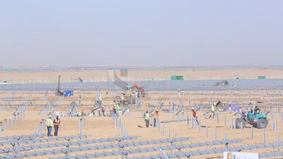 Man driving an excavator in solar energy