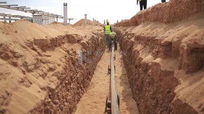Workers burying electric cables