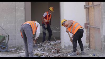 Workers clean the ground of broken bricks, Isolation work