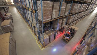 Man riding an order picker inside a warehouse