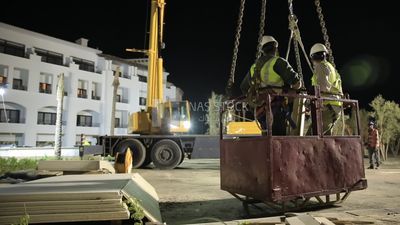 Two workers in a man basket to check the electric