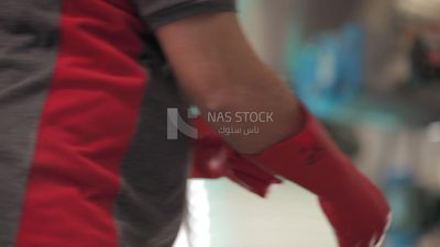 Worker wearing gloves in a factory, factory equipment