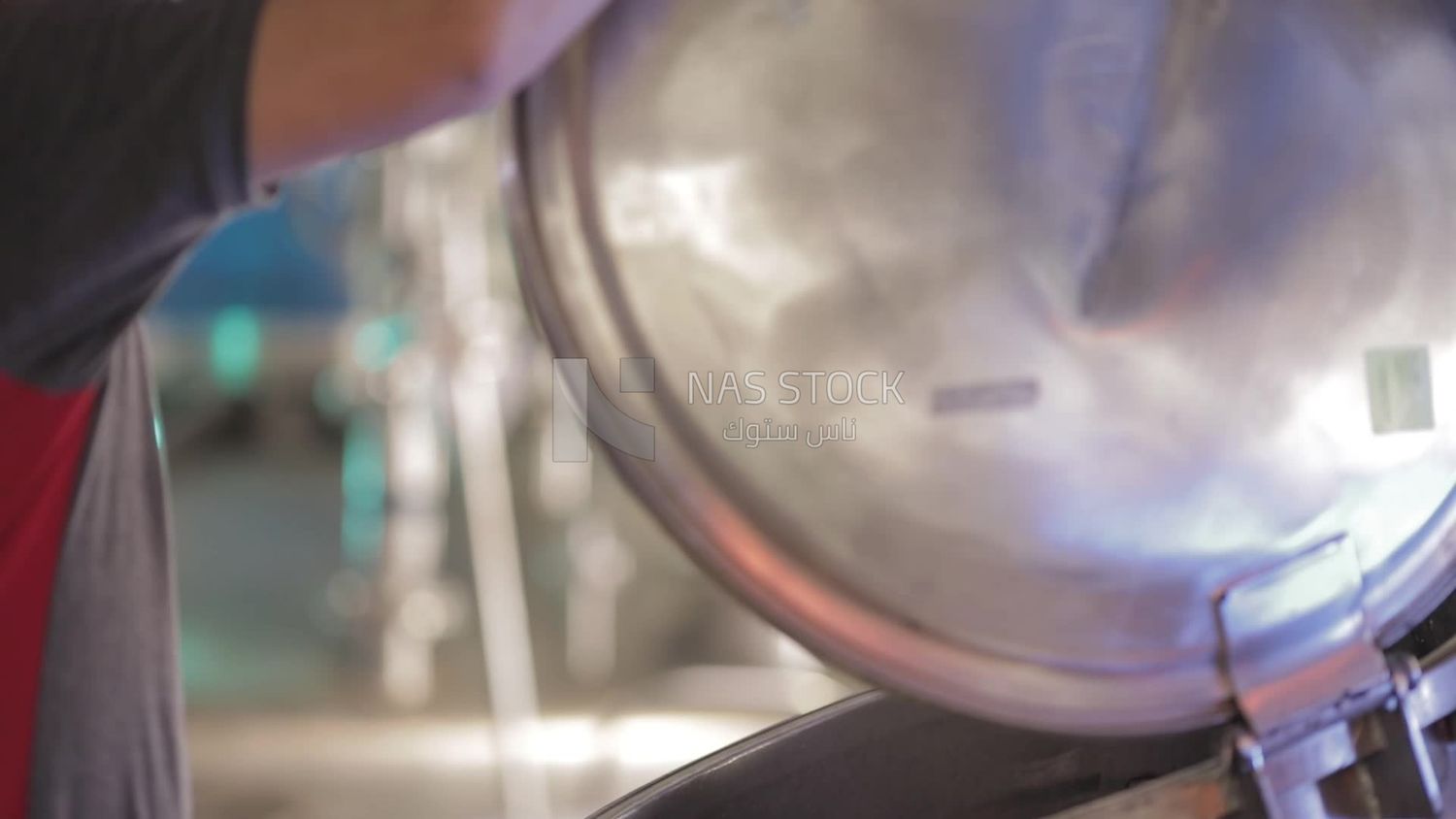 Man opens the door of a machine in a factory, factory equipment