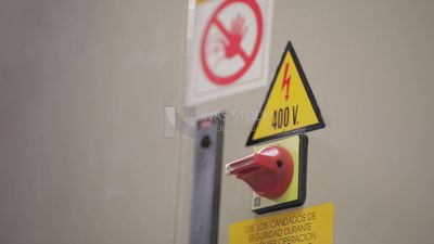 Worker locks the door of a machine in a factory, factory equipment, machine