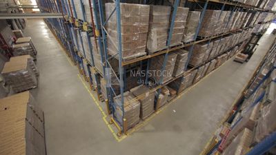 Man riding an order picker inside a warehouse