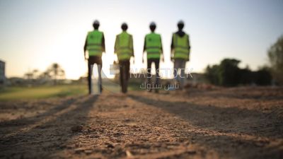 Close-up video of construction workers walking on site