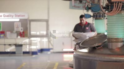 Man opens the door of a machine in a factory, factory equipment