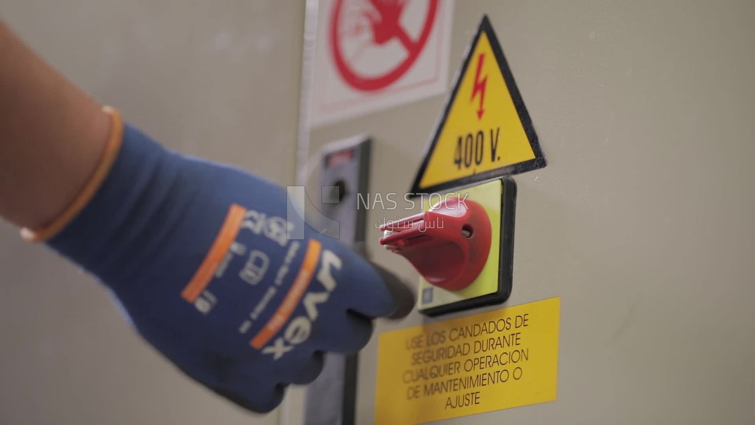 Worker locks the door of a machine in a factory, factory equipment, machine