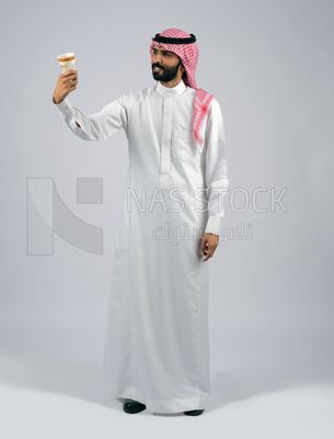 Gulf man holding a cup of coffee