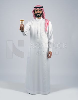 Gulf man holding a cup of coffee